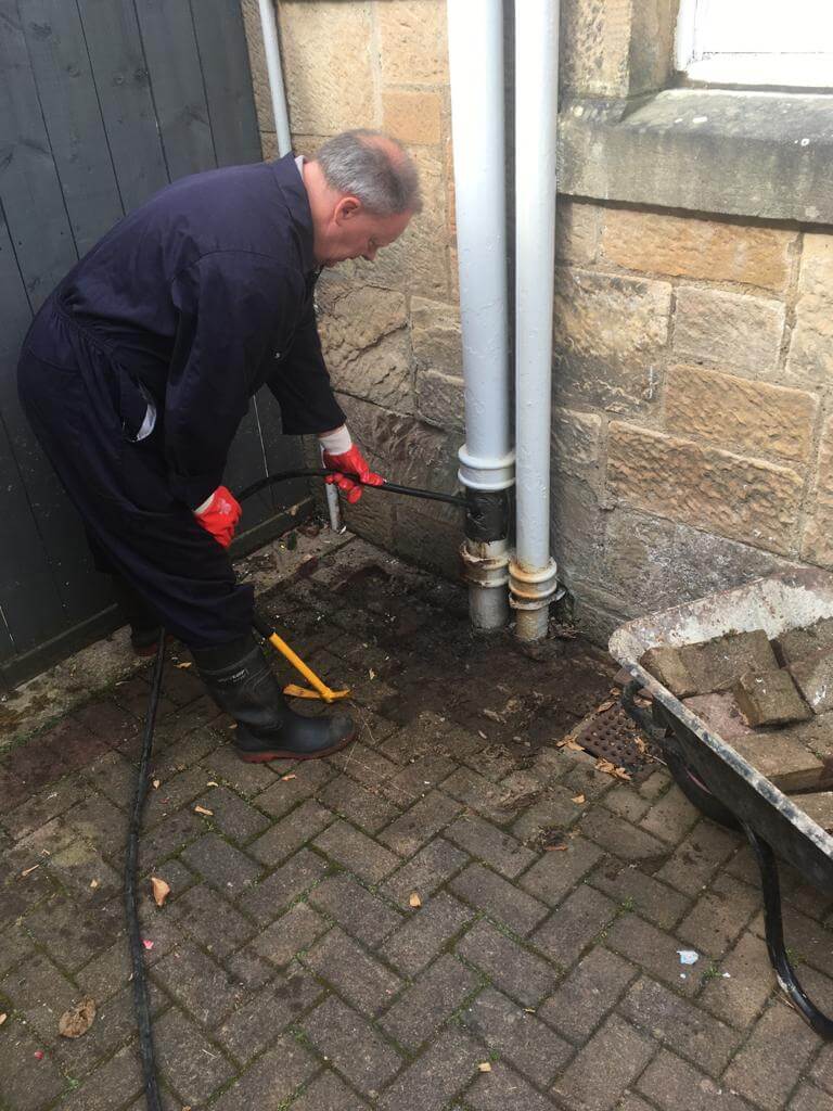 Drain inspection technician at work